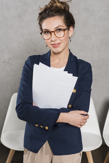 Photo front view of smiley woman from human resources holding papers