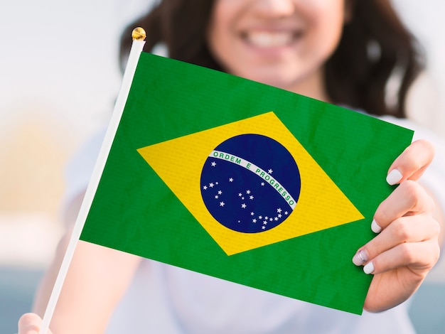 Front view smiley woman holding flag