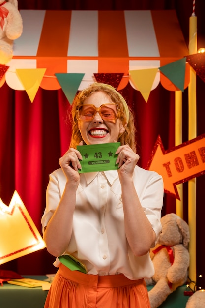 Front view smiley woman holding tombola ticket