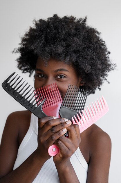 Front view smiley woman using hair combs