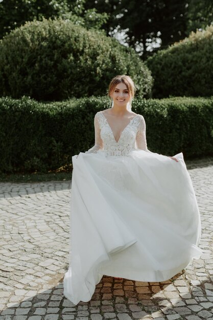 Front view of smiling bride walking in the park. Concept of bride