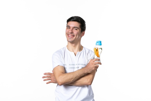 Front view smiling young male holding bottle of lemonade on white background skin fruit juice fresh drink liquid horizontal human cool soda