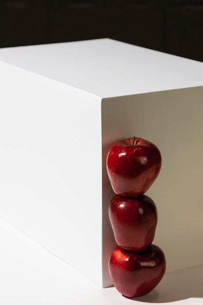 Front view of stacked red apples next to podium