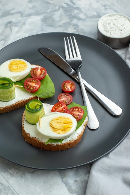 front view tasty egg sandwiches with knife and fork inside plate white background sandwich diet toast health burger bread meal lunch