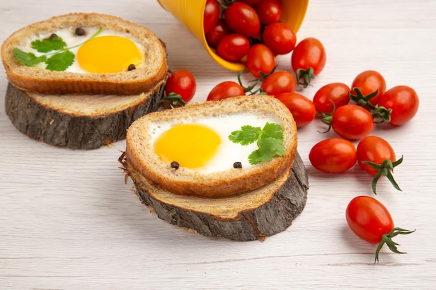 Front view tasty egg toasts with tomatoes on white background food color breakfast salad photo morning meal lunch