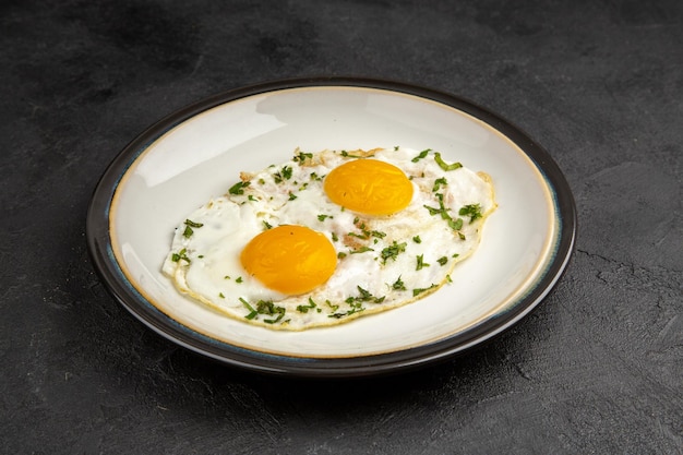 Front view tasty scrambled eggs inside plate on dark background
omelette food breakfast morning lunch bread tea meal