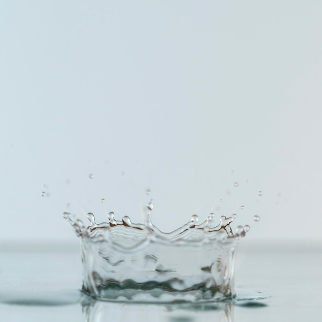 Front view of water splash from drop with copy space