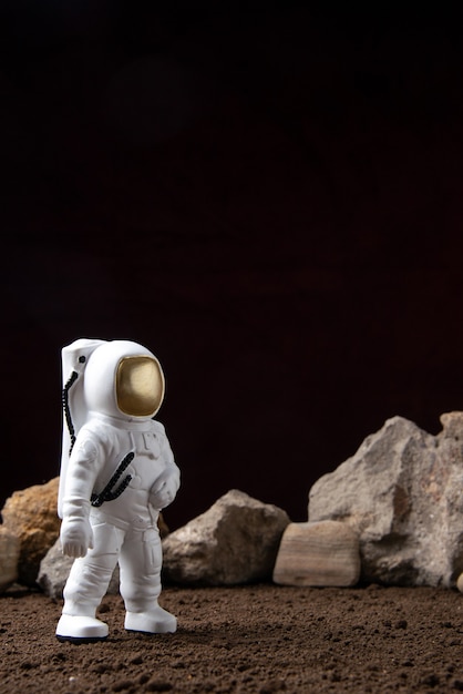 Front view of white astronaut with different rocks on moon cosmic sci fi fantasy