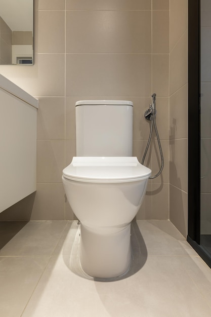 Front view of white toilet bowl in a modern bathroom sanitary equipment for a home