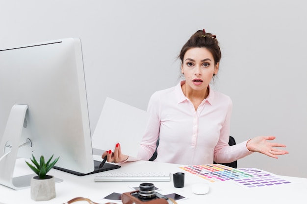 Front view of woman at desk having no idea what just happened