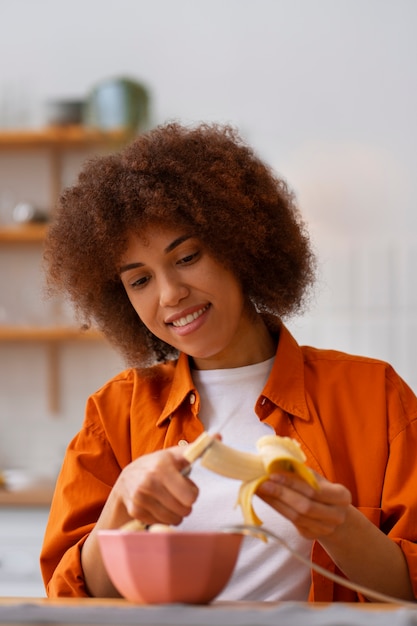 Front view woman eating banana