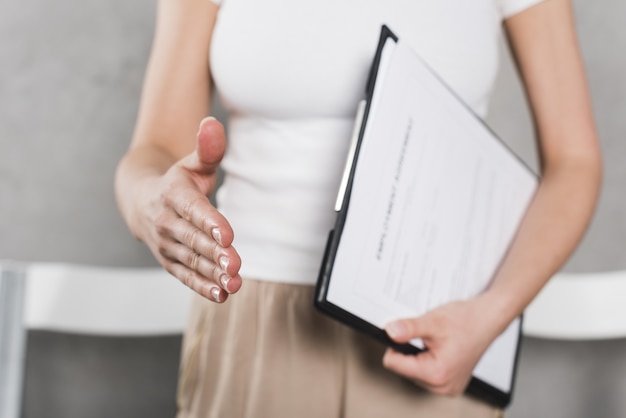 Front view of woman from human resources shaking hand before interview