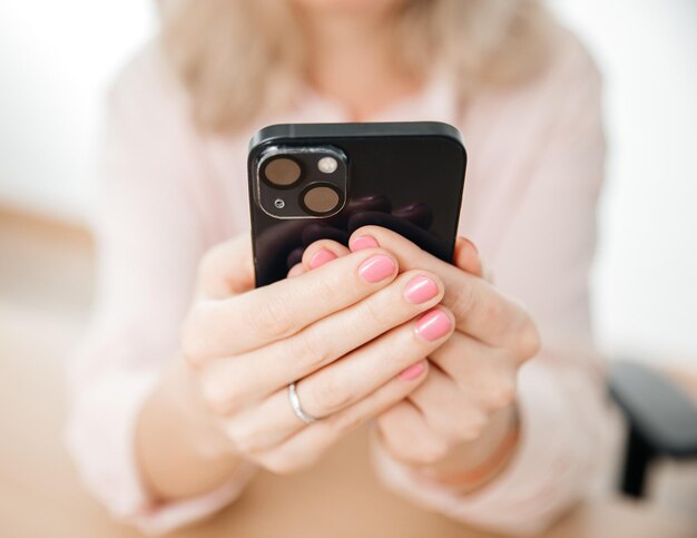 Front view of woman hand using mobile phone work and communication concept home office