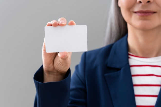 Photo front view woman holding blank business card