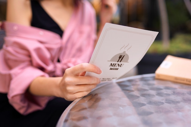 Front view woman holding menu