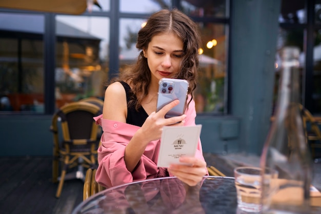 front view woman holding smartphone