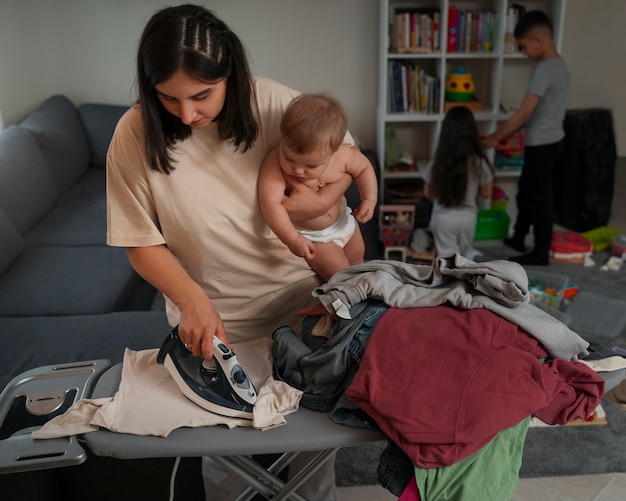 Photo front view woman ironing clothes