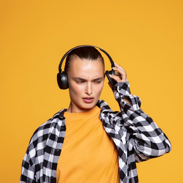 Front view of woman listening to music on headphones