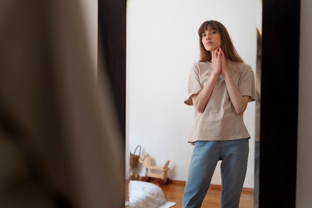 Front view woman looking in the mirror