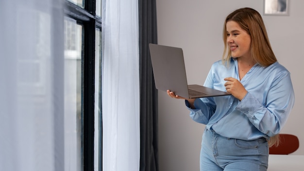 Photo front view woman making video calls with laptop