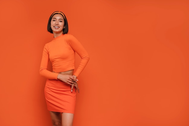 Front view woman posing with orange outfit