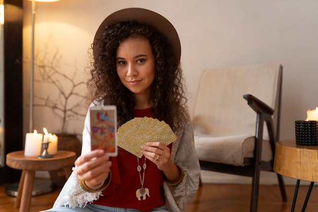 Front view woman reading tarot at home