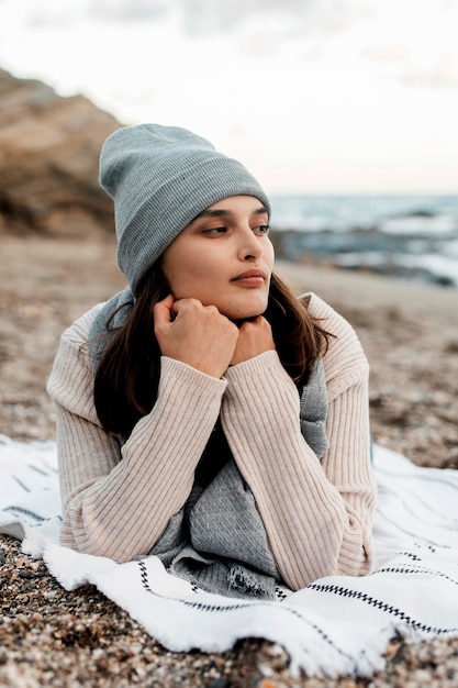 Front view of woman resting at the beach alone