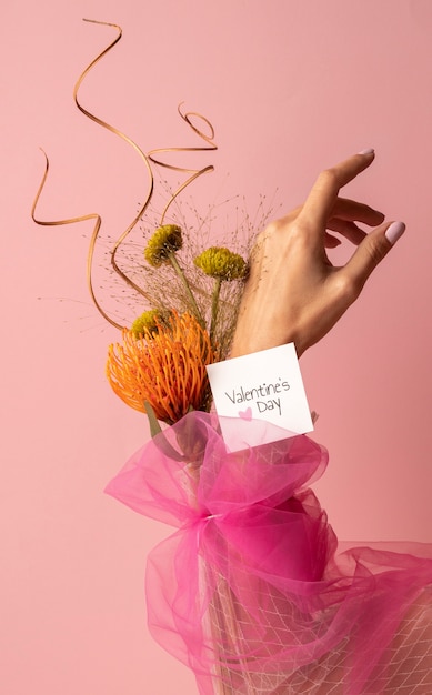 Front view of woman's hand with flowers for valentines day