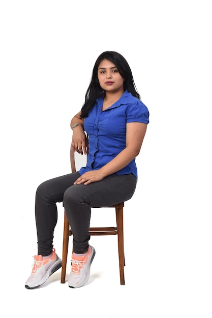 Front view of a woman sitting on chair onwhite background