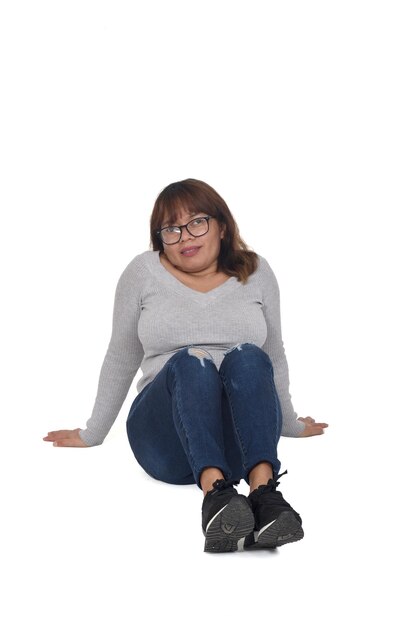 Front view of woman sitting on the floor on white background