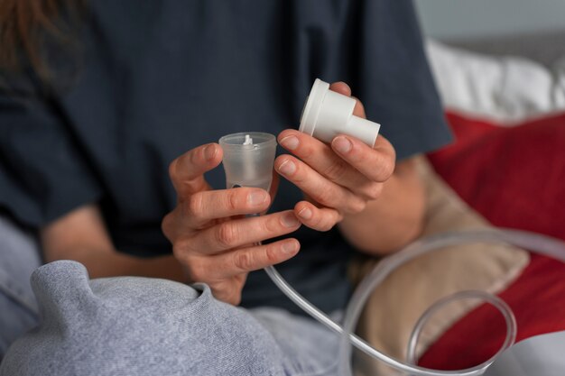 Front view woman using nebulizer at home