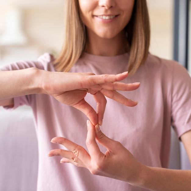 Foto vista frontale della donna che usando il linguaggio dei segni