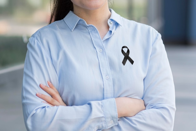 Front view woman wearing black mourning ribbon