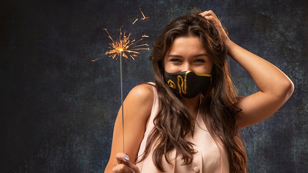 Front view of woman wearing a mask with a firework