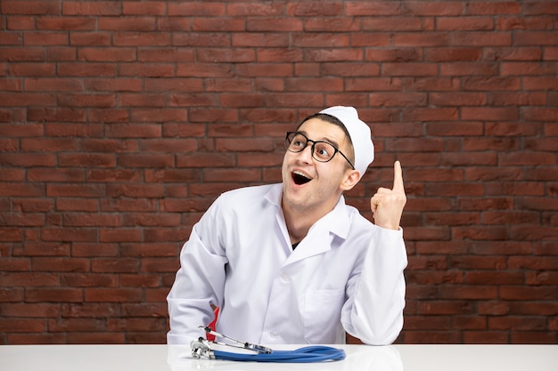 Front view young doctor in white medical suit