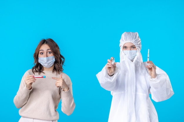 front view young female doctor in protective suit with patient on blue background science disease covid- pandemic health isolation virus medical