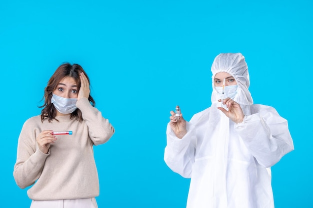 front view young female doctor in protective suit with patient on blue background science disease medical virus covid- health isolation