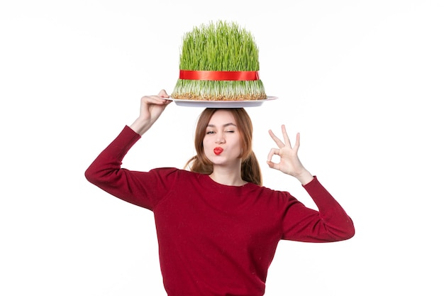 front view young female holding big green novruz semeni on her head on white background spring ethnic performer ethnicity concept holiday family