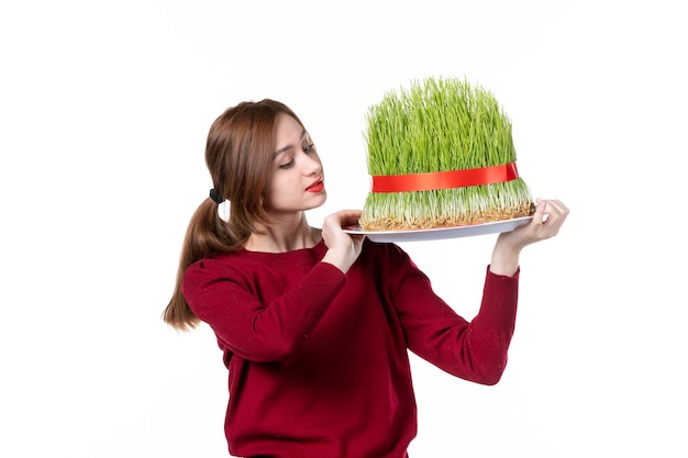 front view young female holding big green novruz semeni on white background spring ethnic performer concept colours holiday family