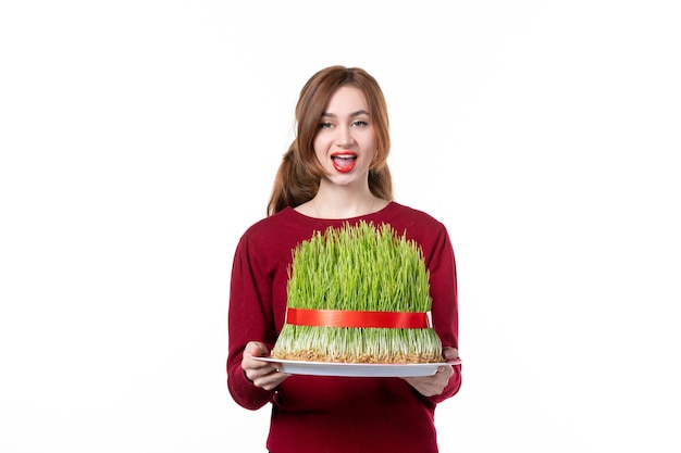 front view young female holding big green novruz semeni on white background spring ethnic performer ethnicity colours holiday family