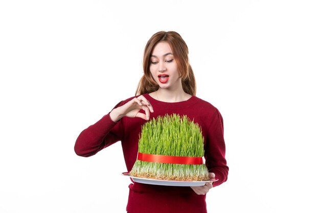 front view young female holding big green novruz semeni on white background spring ethnic performer ethnicity concept colours holiday