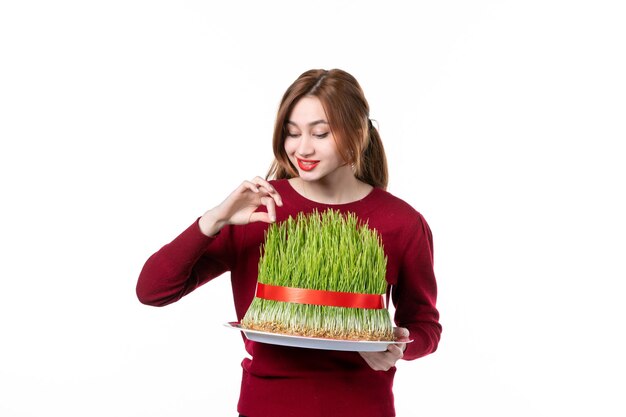 front view young female holding big green novruz semeni on white background spring ethnic performer ethnicity concept family colour holiday