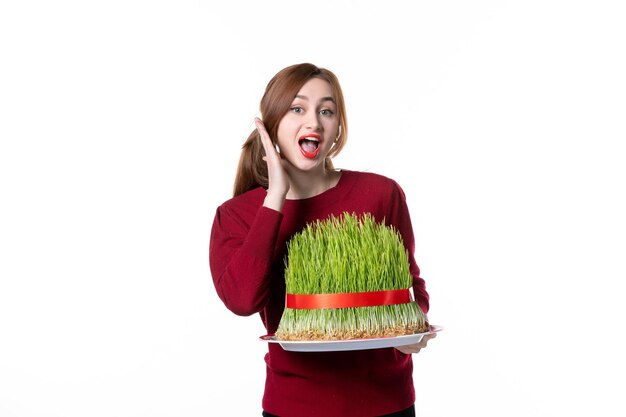 front view young female holding big green novruz semeni on white background spring ethnic performer ethnicity concept family colours holidays