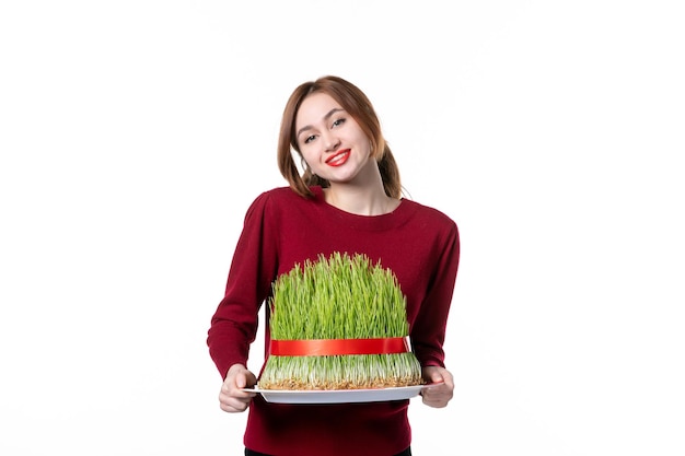 front view young female holding big green novruz semeni on white background spring ethnic performer ethnicity holiday concept colours