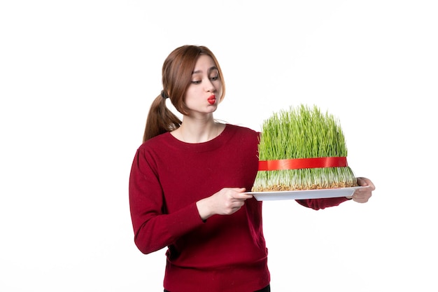 front view young female holding big green novruz semeni on white background spring ethnic performer ethnicity holidays concept family colours