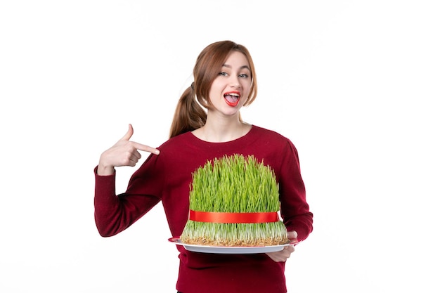 front view young female holding big green novruz semeni on white background spring ethnic performers ethnicity concept family colours holiday