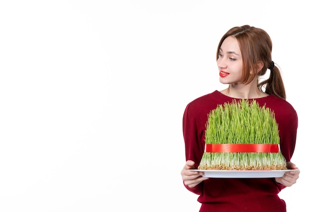 front view young female holding big novruz semeni on white background concept ethnicity family ethnic spring performer colours