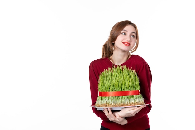 front view young female holding big novruz semeni on white background concept ethnicity family holiday performer colours ethnic spring