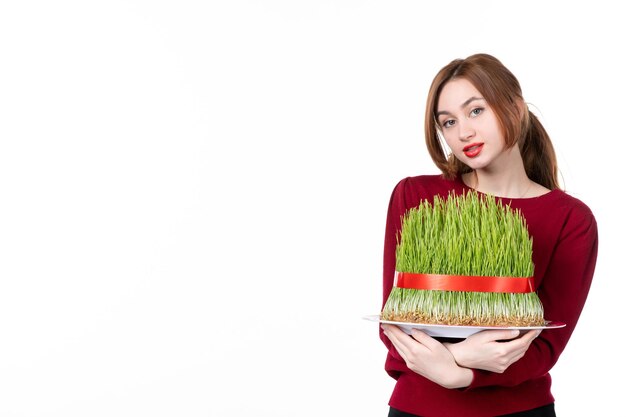 front view young female holding big novruz semeni on white background concept ethnicity family holiday performers colours ethnic spring