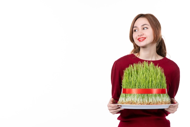 front view young female holding big novruz semeni on white background ethnicity family ethnic holiday concept spring performers colours